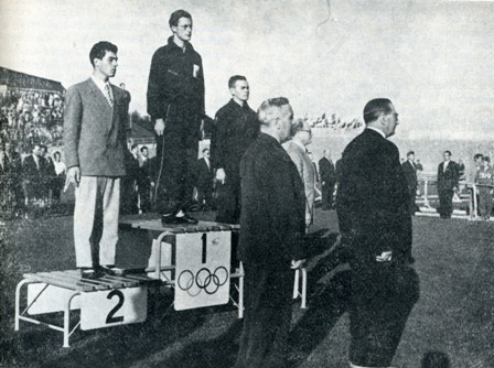 Russell Mockridge on Victor's dais <br/>after 100m Time Trial Helsinki Olympic Games, 1952.